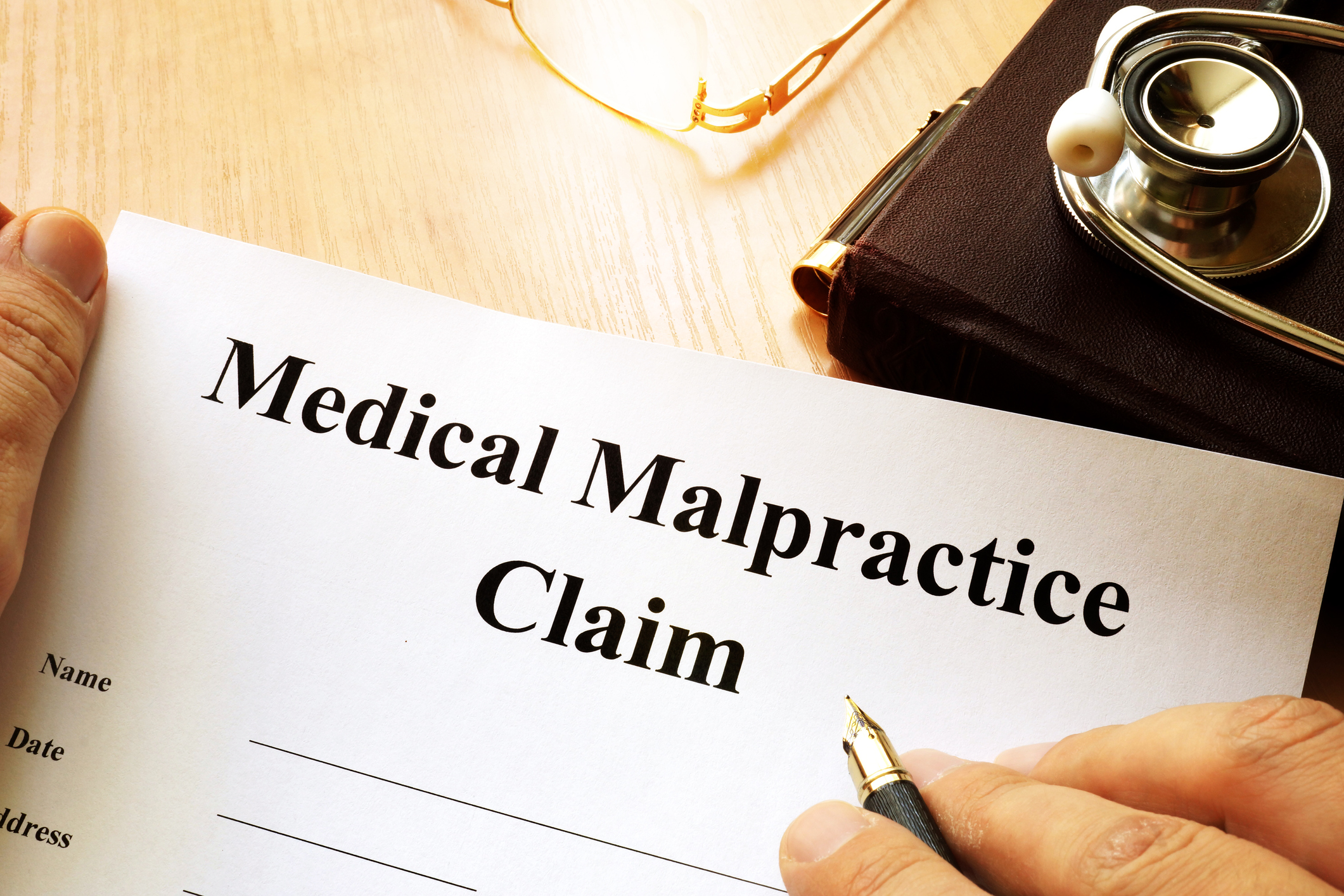 Medical Malpractice Claim on a table.